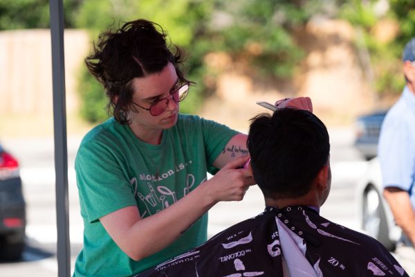 Bridgewood Church of Christ member Catie Mckee gives a free haircut during the congregation's regular Saturday food giveaway.