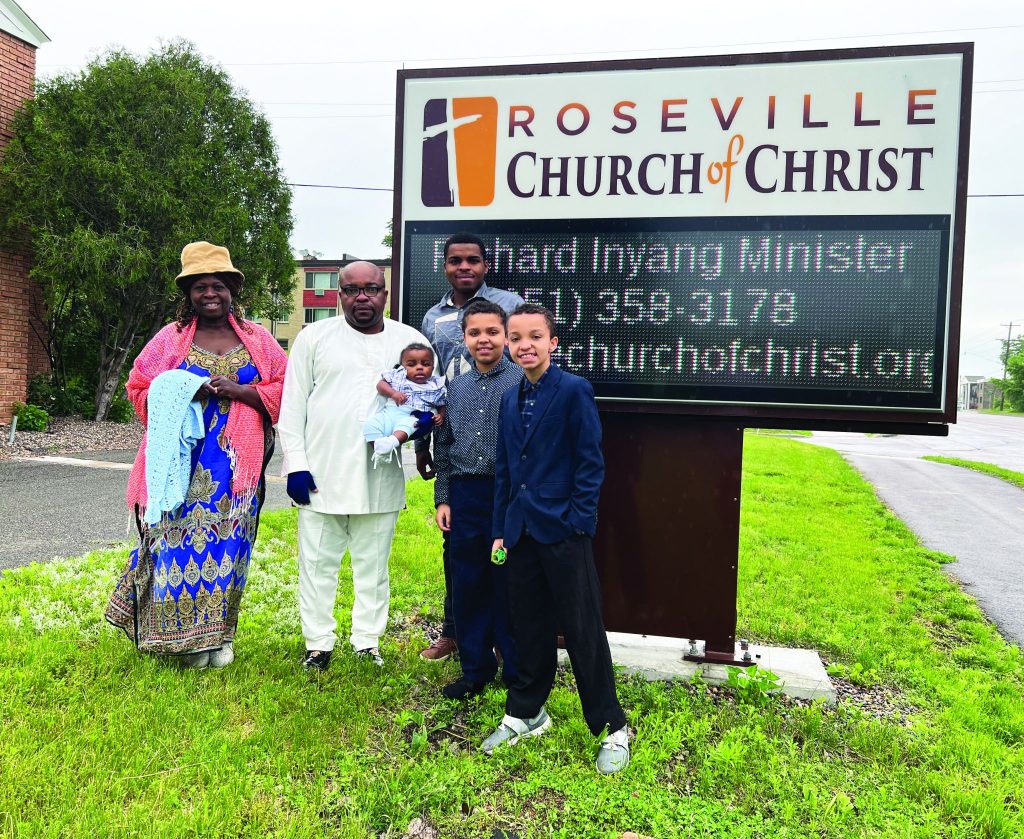 The Inyang family poses for a photo by the Roseville Church of Christ sign. Richard Inyang has served as the congregation’s minister for 15 years.
