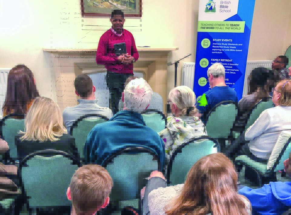 Sola Adeoson gives a communion devotional during the recent British Bible School Winter Family Retreat.