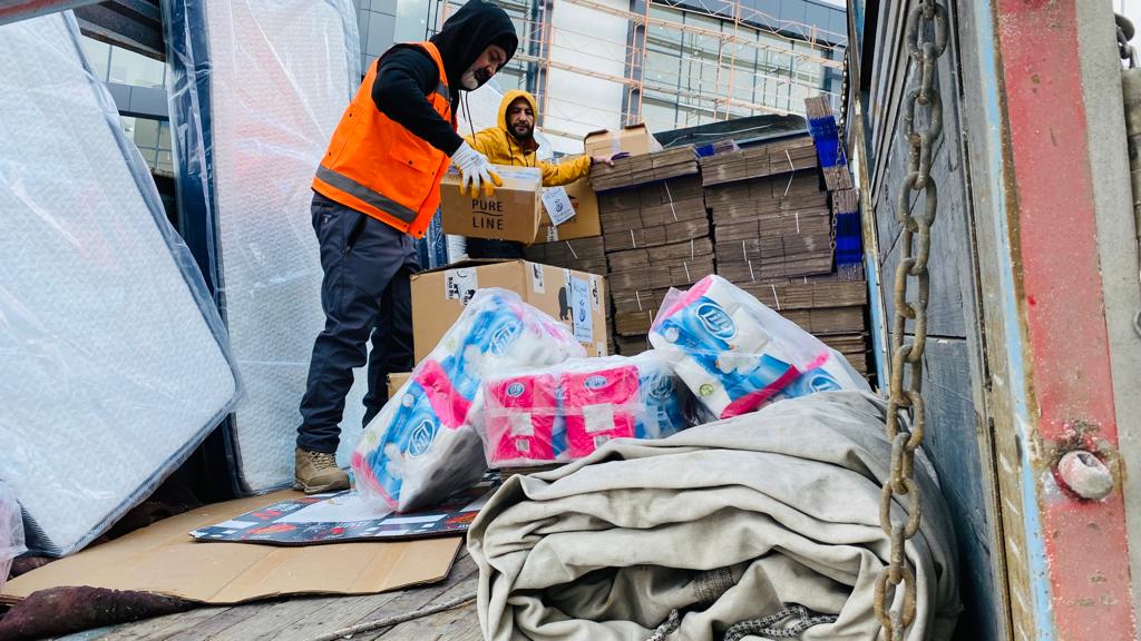Workers with First Hope Association unload aid in Gaziantep, Turkey.