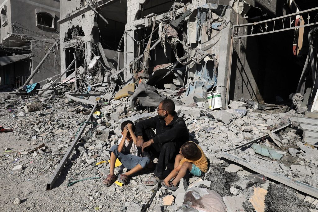 Palestinians search a house after an Israeli air strike, in the city of Rafah, south of the Gaza Strip, on October 12 2023.