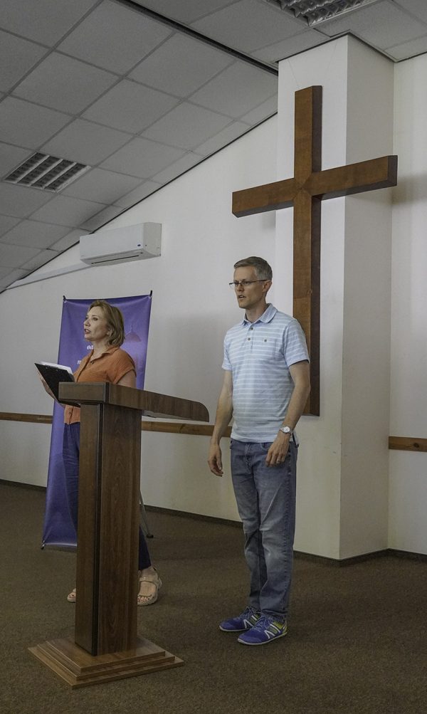 Brandon Price welcomes guests to the retreat and Ukrainian Bible Institute graduation as UBI administrator Natalia Maliuga translates his words into Ukrainian. Price is fluent in Ukrainian but spoke in English for the benefit of overseas visitors.
